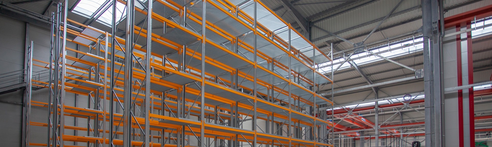  Rayonnage à palettes et plateforme industrielle installés dans un entrepôt
											
